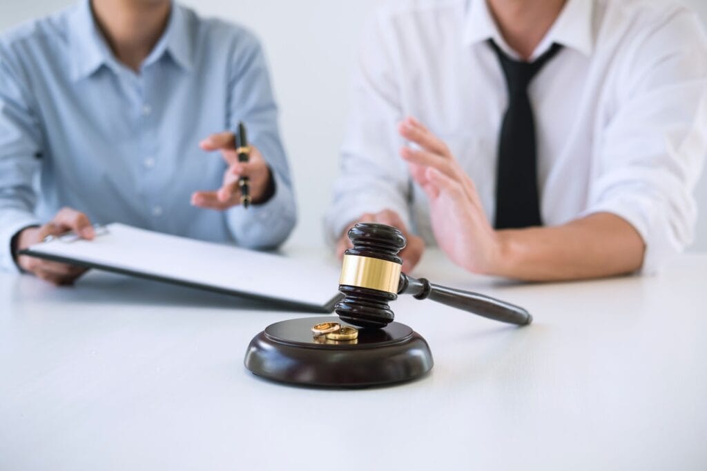 Contract decree of divorce (dissolution or cancellation) of marriage, husband and wife during divorce process and signing of divorce contract, Wedding ring